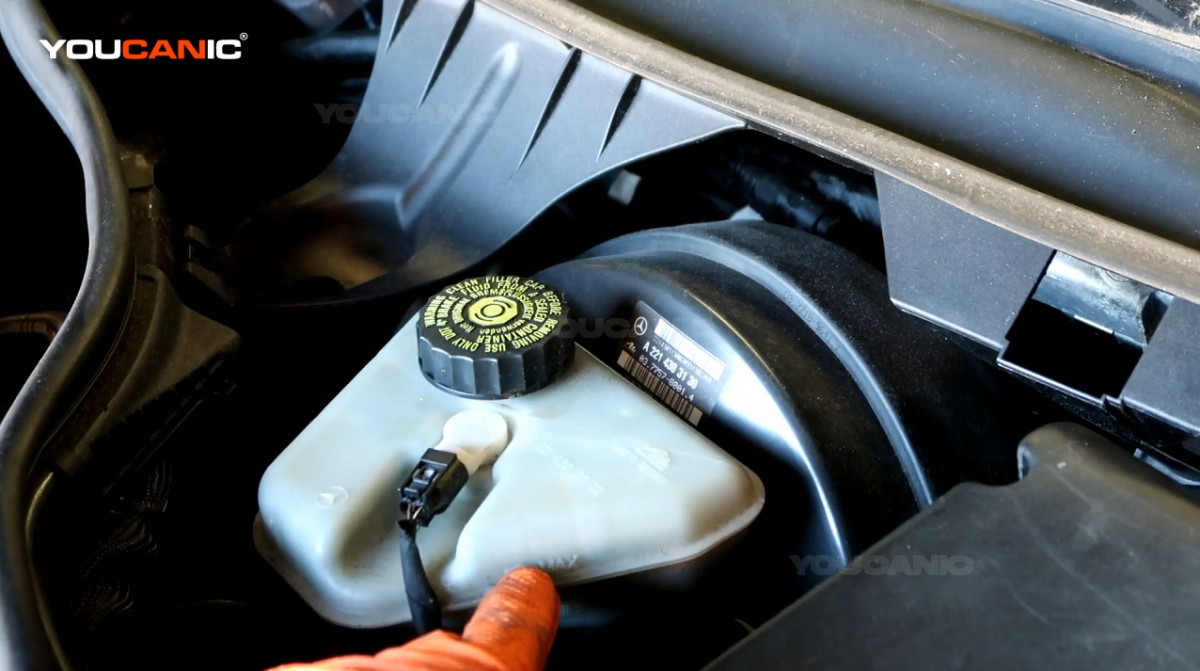 Checking the brake fluid level of the vehicle.
