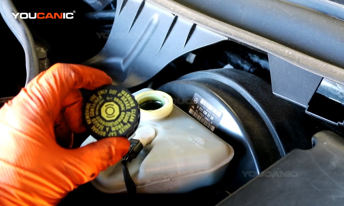 Pouring the brake fluid in.