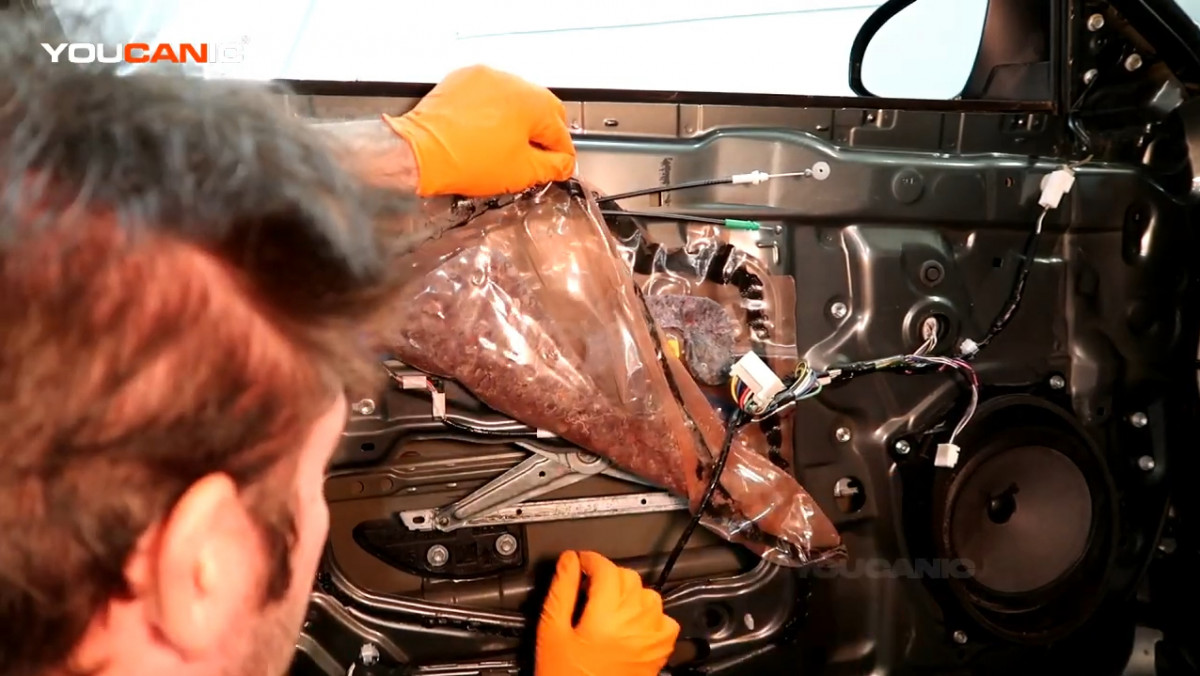 Pulling the plastic cover on the door up.