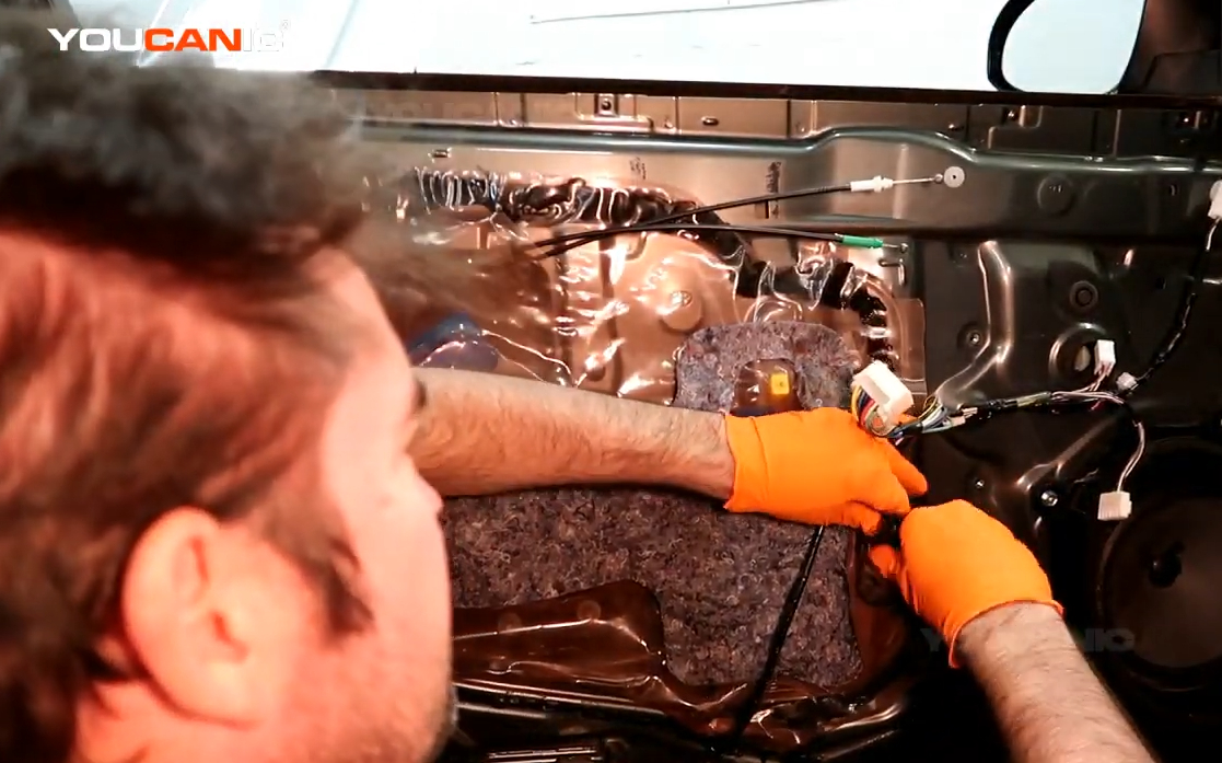 Removing the bolts holding the window regulator.