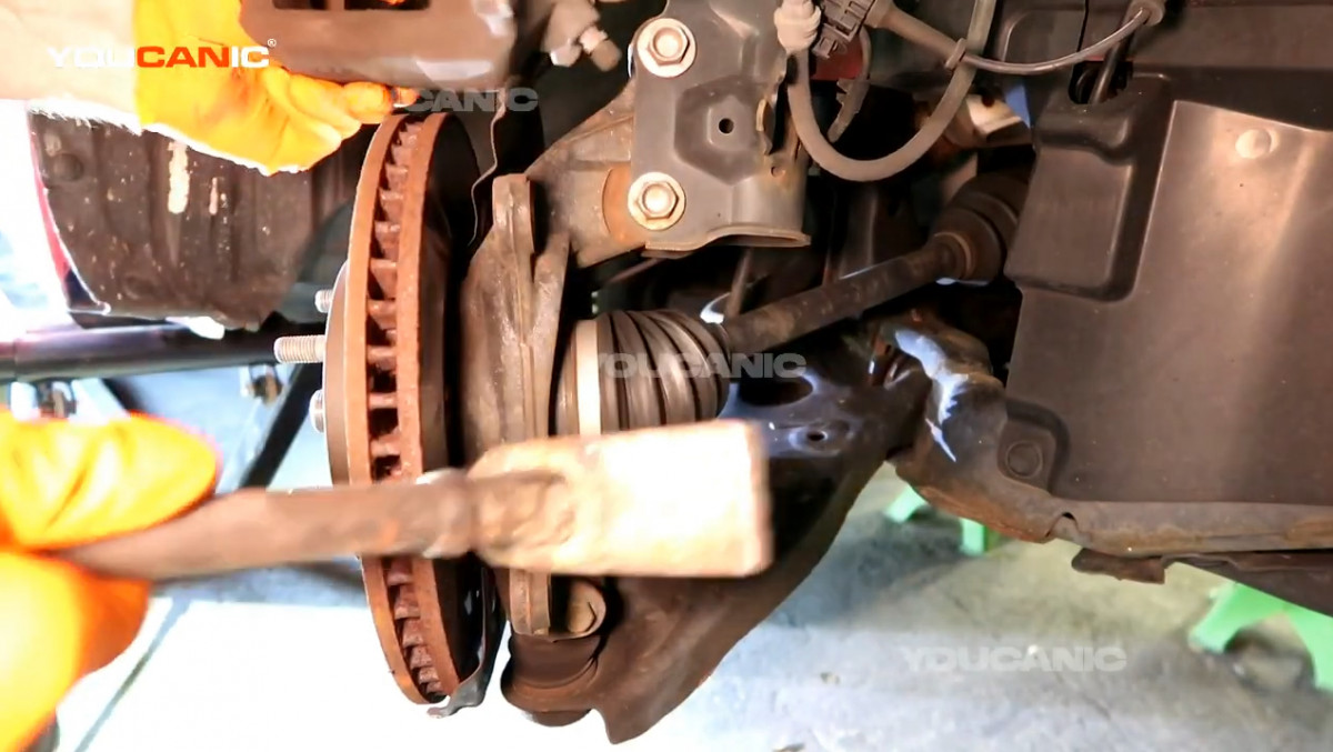 Removing the rotor out from the vehicle.