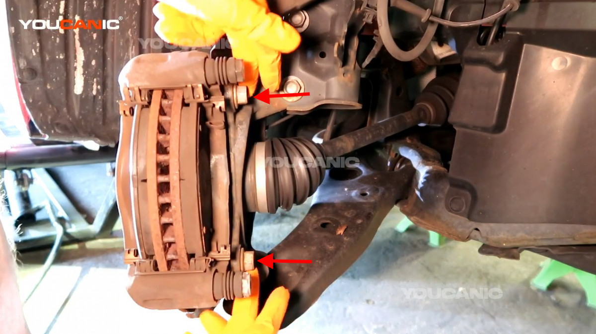 The 17mm bolts holding the caliper carrier.