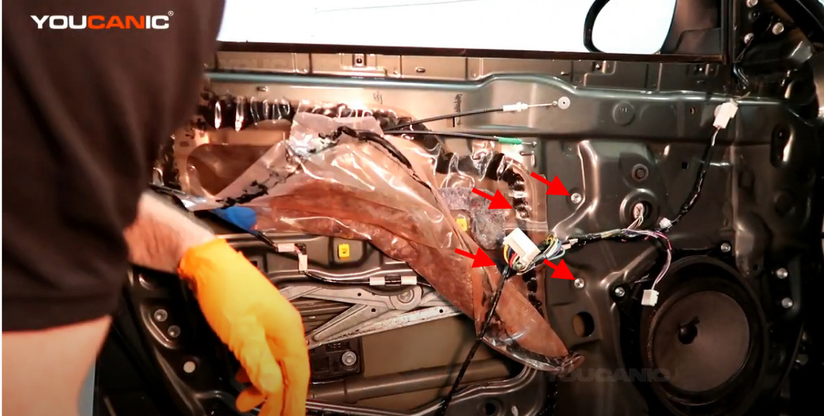 The bolts holding the window regulator.
