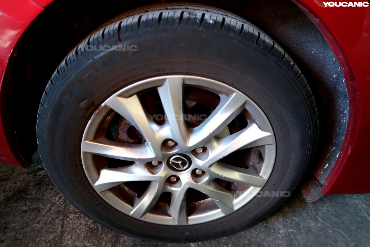 Loosening the lug nuts on the front wheel.